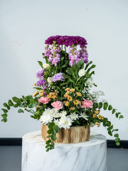 Delistar purple and mathiola and vesiayanthus and baby chrysantimum and carnetion pink chrysantimum white wooden pot aragement