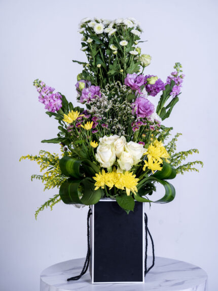 Baby chrysantimum and mathiola snd vesiathys white rose Chrisanthymum yellow box Arrangement